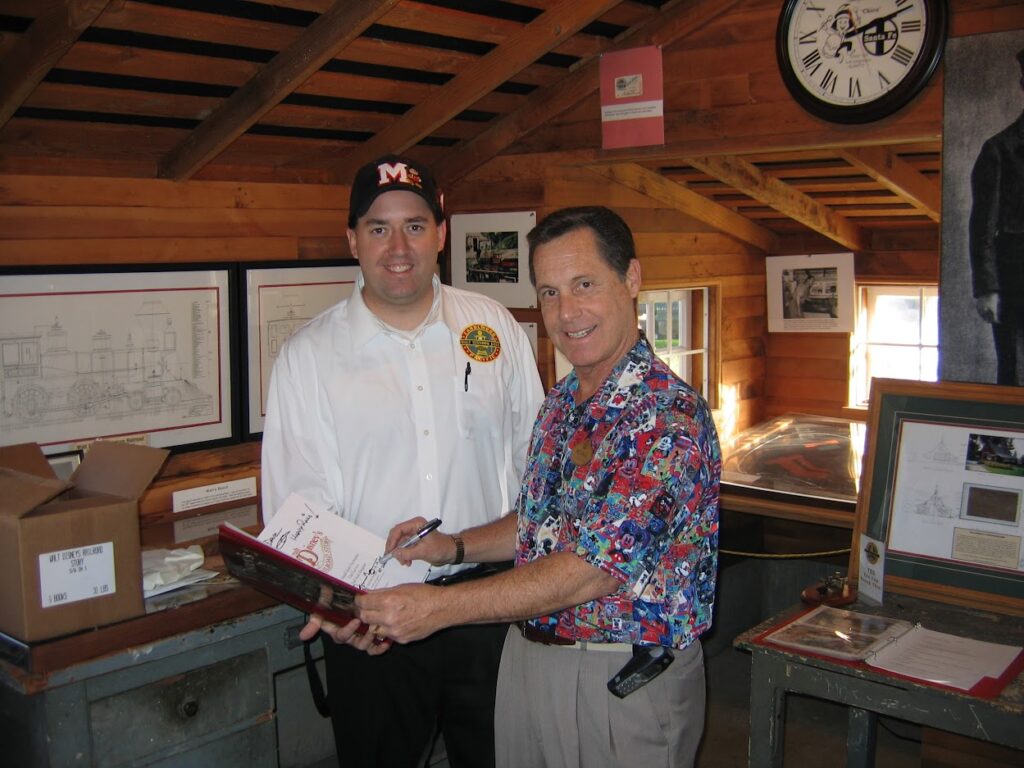 Michael signing my first copy of his book at Walt's Barn on December 19, 2004. | Marceline Emporium